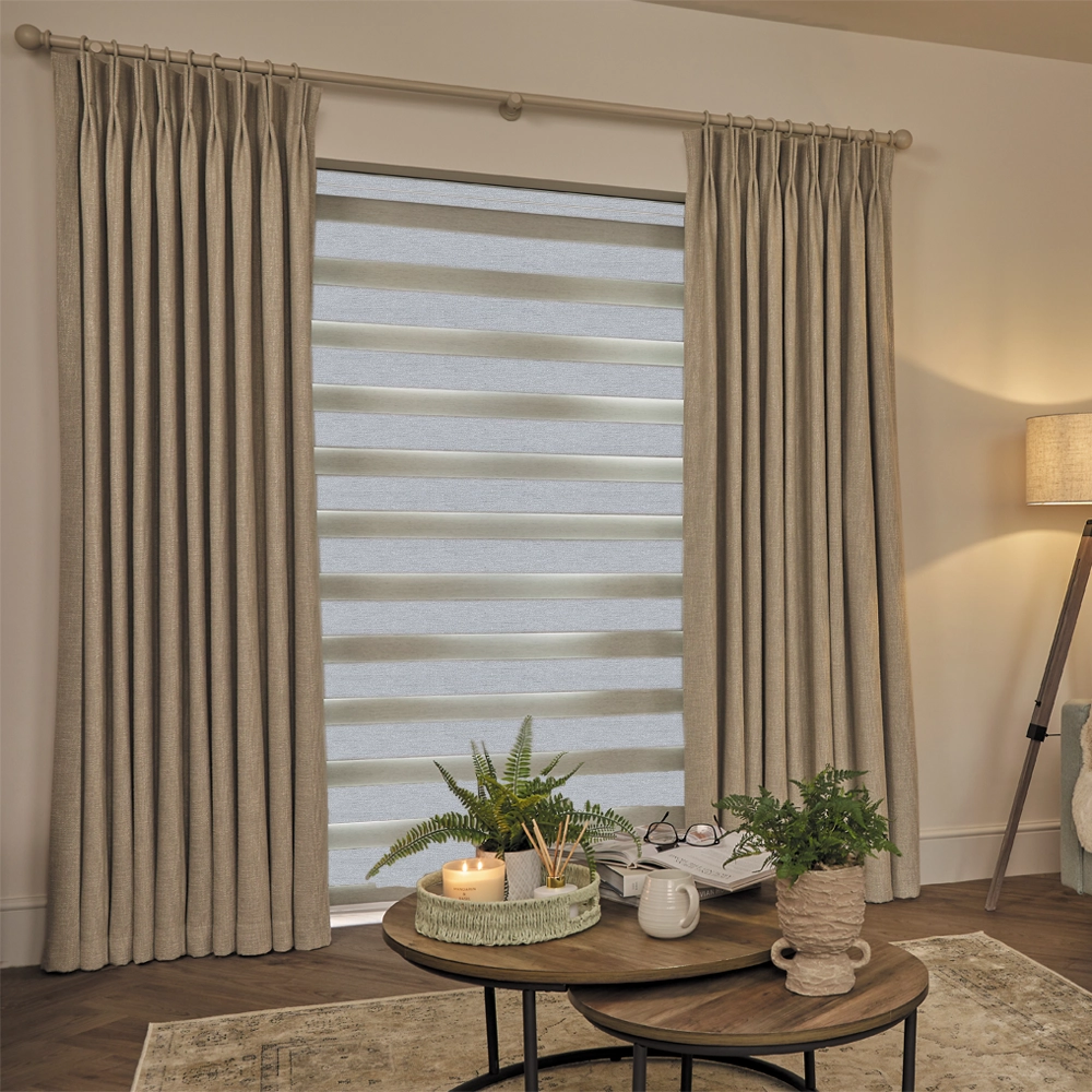 Made to measure Lustre Silver Blackout Day and Night Blinds with alternating blackout and sheer fabric panels.